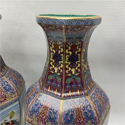Pair of 20th century Chinese vases, of octagonal baluster form, each central panel decorated with one of The Eight Immortals, bordered by panels of floral motifs upon a pink/purple ground, H33.5cm