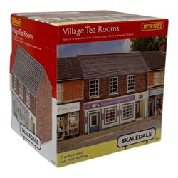Ten Hornby '00' gauge Skaledale buildings, comprising R9834 Village Tea Rooms, R8506 Brambles Cottage, R8507 Platt's General Store, R8503 St Michaels School, R9769 The Pine Shop, R8641 Platform Footbridge, R8639 Water Tower, R8587 Coal Stage, R8589 Level Crossing Signal Box and R8638 Platform Shelter, all boxed