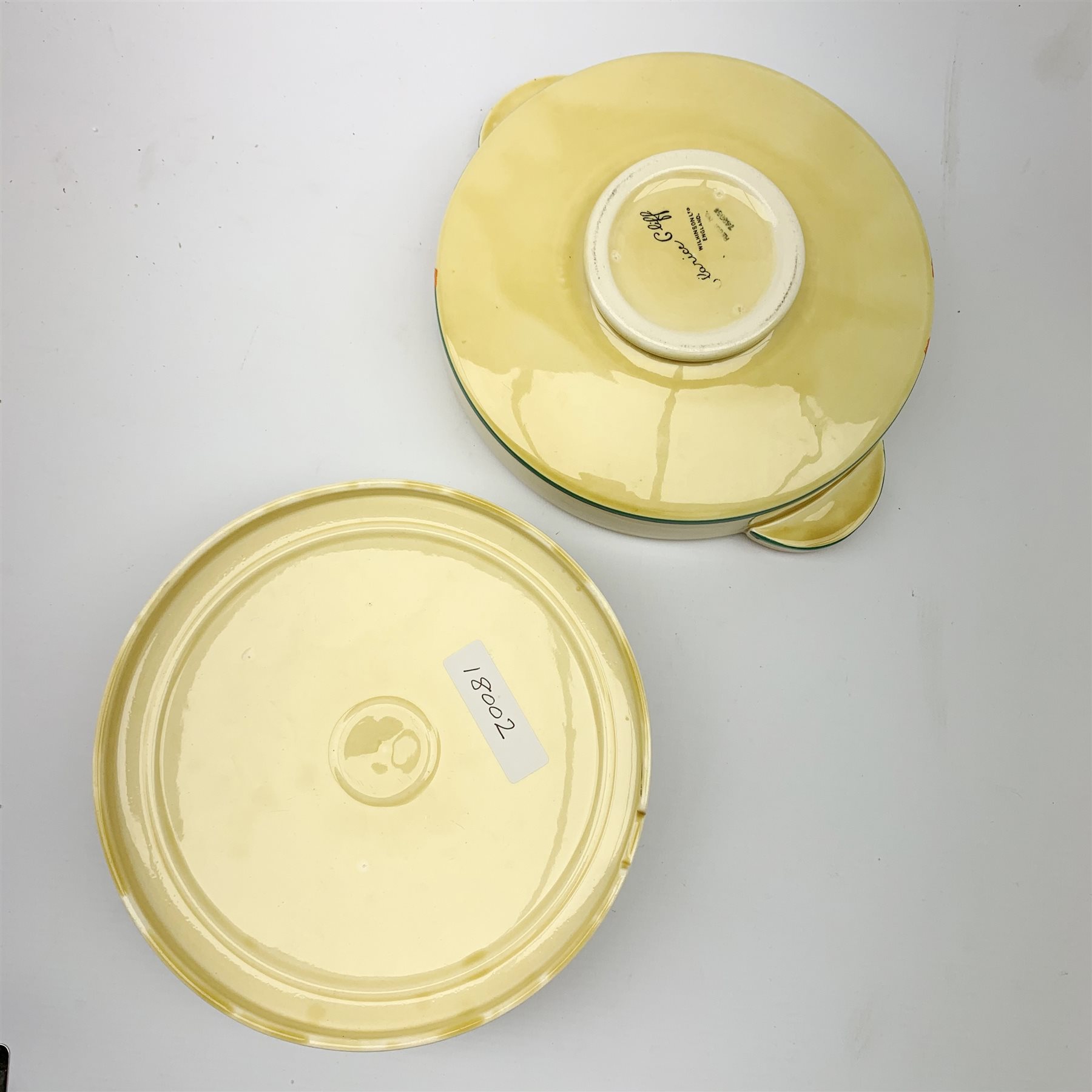 A Clarice Cliff Bizarre by Wilkinson/Newport Pottery vegetable tureen and cover, dinner plate and two dessert plates in the Ravel pattern. (4).