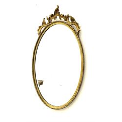 Gilt oval mirror with beading decoration, H65.6cm. 