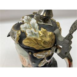 Otto Von Bismarck figural 0.5l stein, his black pickelhaube helmet with chrome spike serving as the lid, in green uniform and gilt detail throughout, pewter thumb hinge, with blue hash Musterschutz type mark, H18cm
