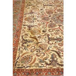 Persian Isfahan ivory and crimson ground rug, the busy field with central floral pole medallion surrounded by foliate motifs and stylised palmettes, the indigo guard line with repeating scrolling plant motifs