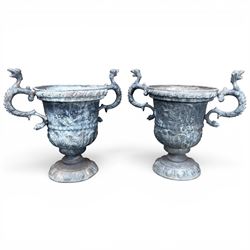 Impressive pair of early highly decorative lead garden urns, griffin handles with ornate decoration depicting cherubs and laurel wreath