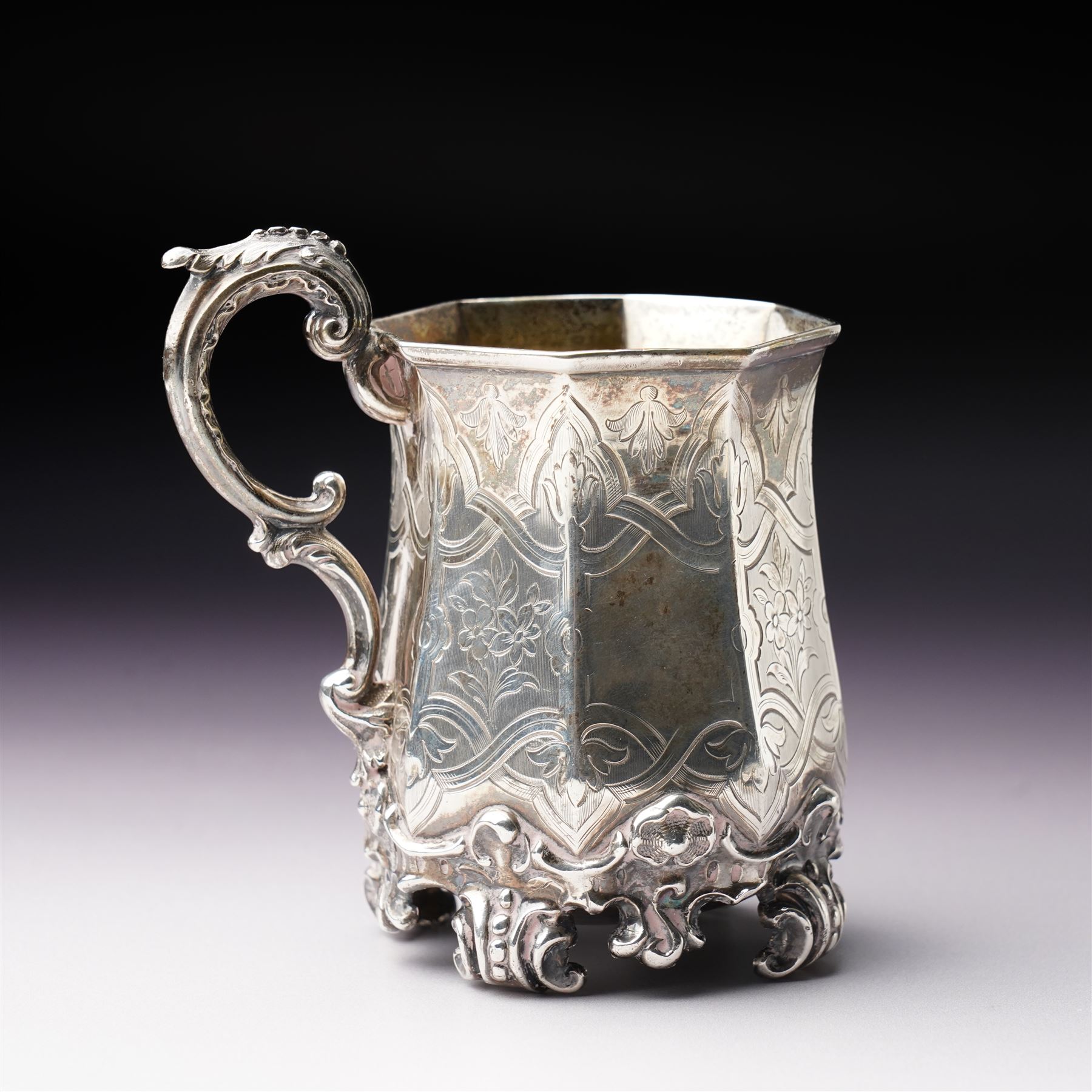 Victorian silver christening mug of panel sided design with gilded interior, engraved decoration and scroll handle and feet H10cm London 1848 Maker Charles Reily & George Storer