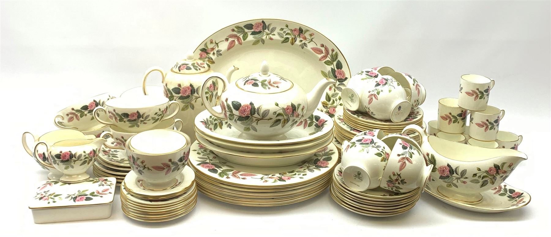Wedgwood Hathaway Rose pattern dinner and tea wares, comprising eight dinner plates, eight salad plates, eight dessert plates, six side plates, six soup bowls and six saucers, sauce boat and stand, three oval serving dishes, oval serving platter, teapot, coffee pot, eight tea cups and eight saucers, eight coffee cans and eight saucers, two open sucriers, milk jug, cream jug, two ashtrays, and a lidded box and cover. 