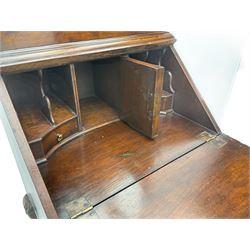 Small early 20th century Queen Anne style bookcase on bureau secretaire, the moulded arched pediment over mirrored door in shaped frame, the bureau fitted with fall front enclosing curved fitted interior, cushion moulded drawer over single drawer, on scroll and shell carved cabriole supports