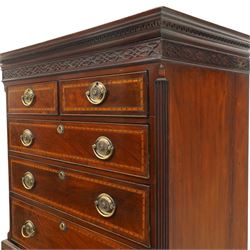  Late 18th century mahogany and inlaid chest on chest, projecting cornice above blind fretwork in laid drawers, the upper chest with two short over three graduating drawers, the lower section with brushing slide over three long graduated drawers, raised on bracket feet