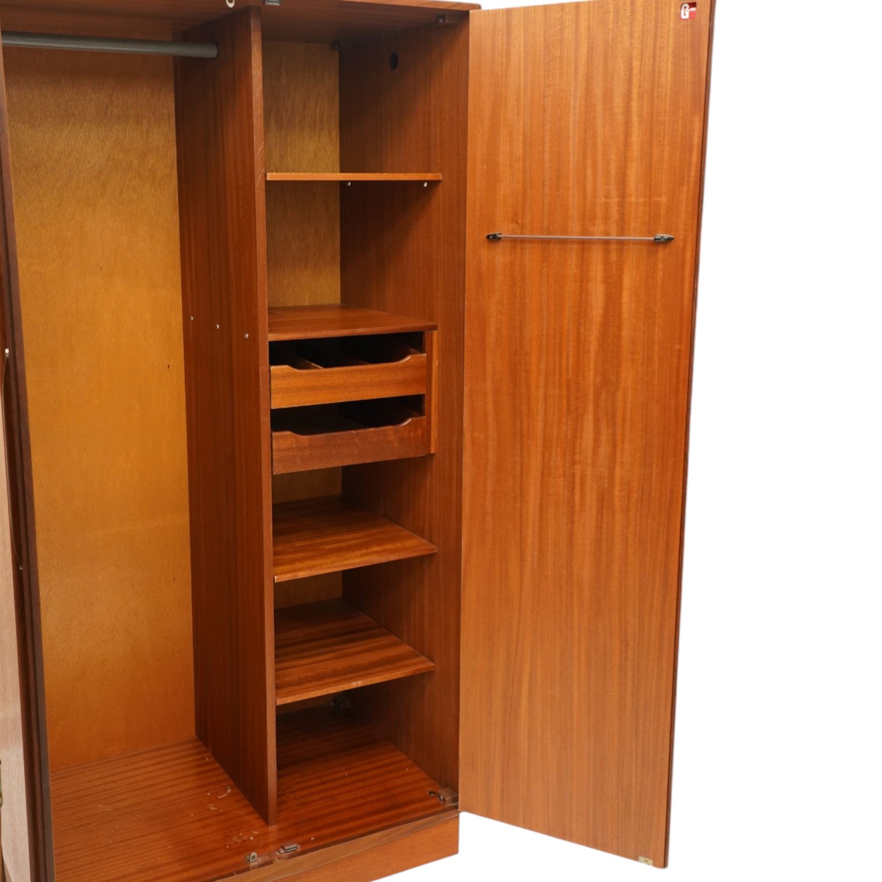 G Plan - 'Fresco' teak double fitted gentleman's wardrobe, twin doors enclosing two sections, a single clothes rail and drawers and shelving, on a recessed plinth base