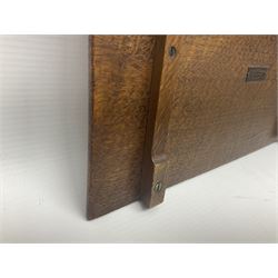 Arts and Crafts oak stand by Arthur Simpson of Kendal, of rectangular form with central hammered pewter panel, surrounded by a border with carved foliate corners, upon two bar supports, bearing label detailed 