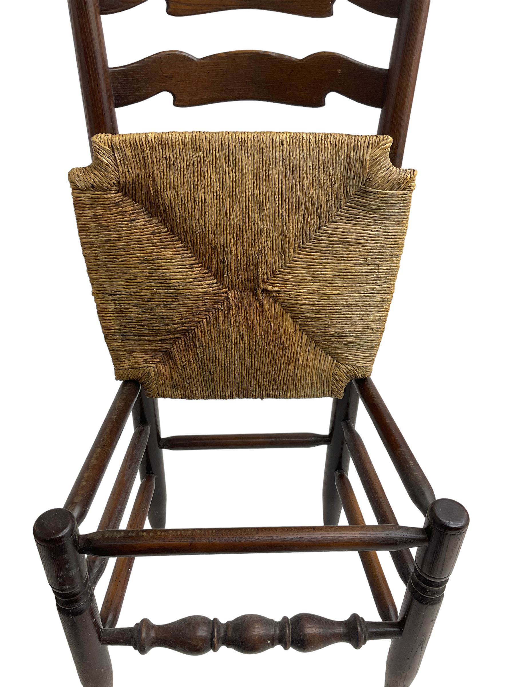 Set eight (6+2) oak dining chairs, high waived ladder back over rush seats, raised on ring turned supports with pad front feet, united by stretchers