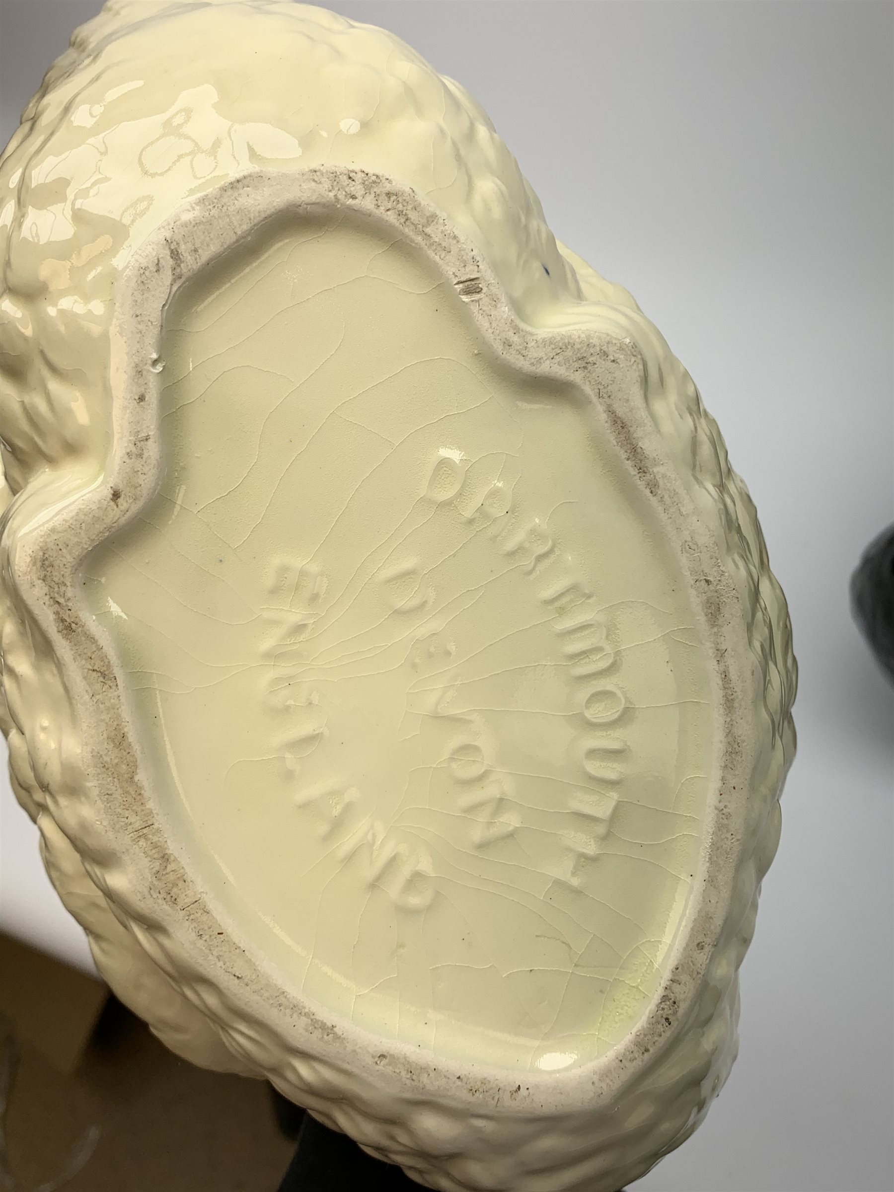 Four Dartmouth pottery jardinières or planters, modelled in the form of swans, comprising three white examples, and one black, marked beneath Dartmouth Devon England, larger examples H29cm, smaller examples H21.5cm. 