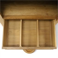 Acorn Industries - oak floor-standing corner cabinet, the top fitted with astragal glazed door enclosing four shaped shelves, the base with single panelled cupboard over two drawers, raised on four stepped feet, carved with acorn signature to top and base, by Alan Grainger, Brandsby