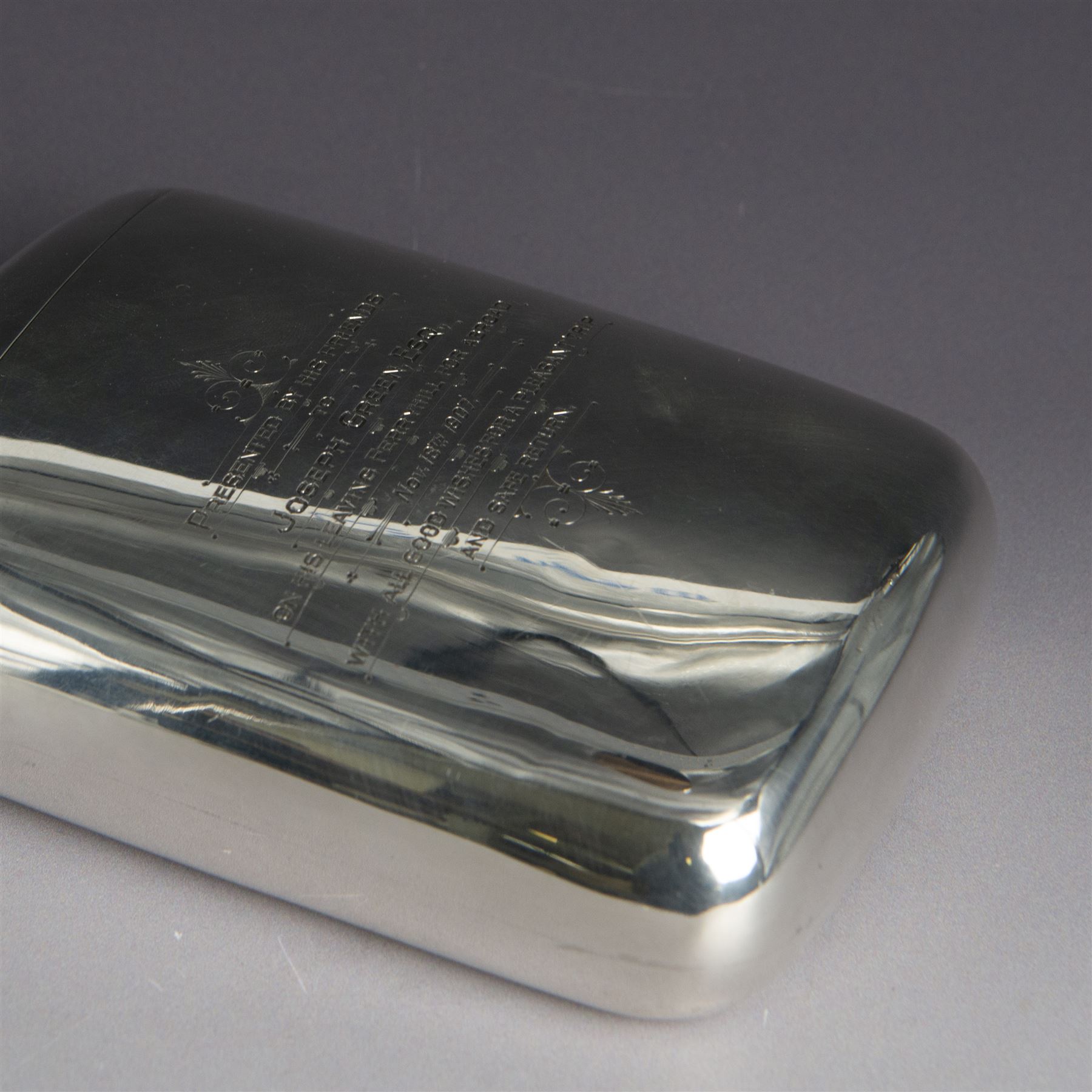 Edwardian silver hip flask, of slightly curved rectangular form, with silver body, hinged cap and removable silver cup, the cup with presentation engraving and gilt interior, hallmarked Hilliard & Thomason, Birmingham 1904, H17cm