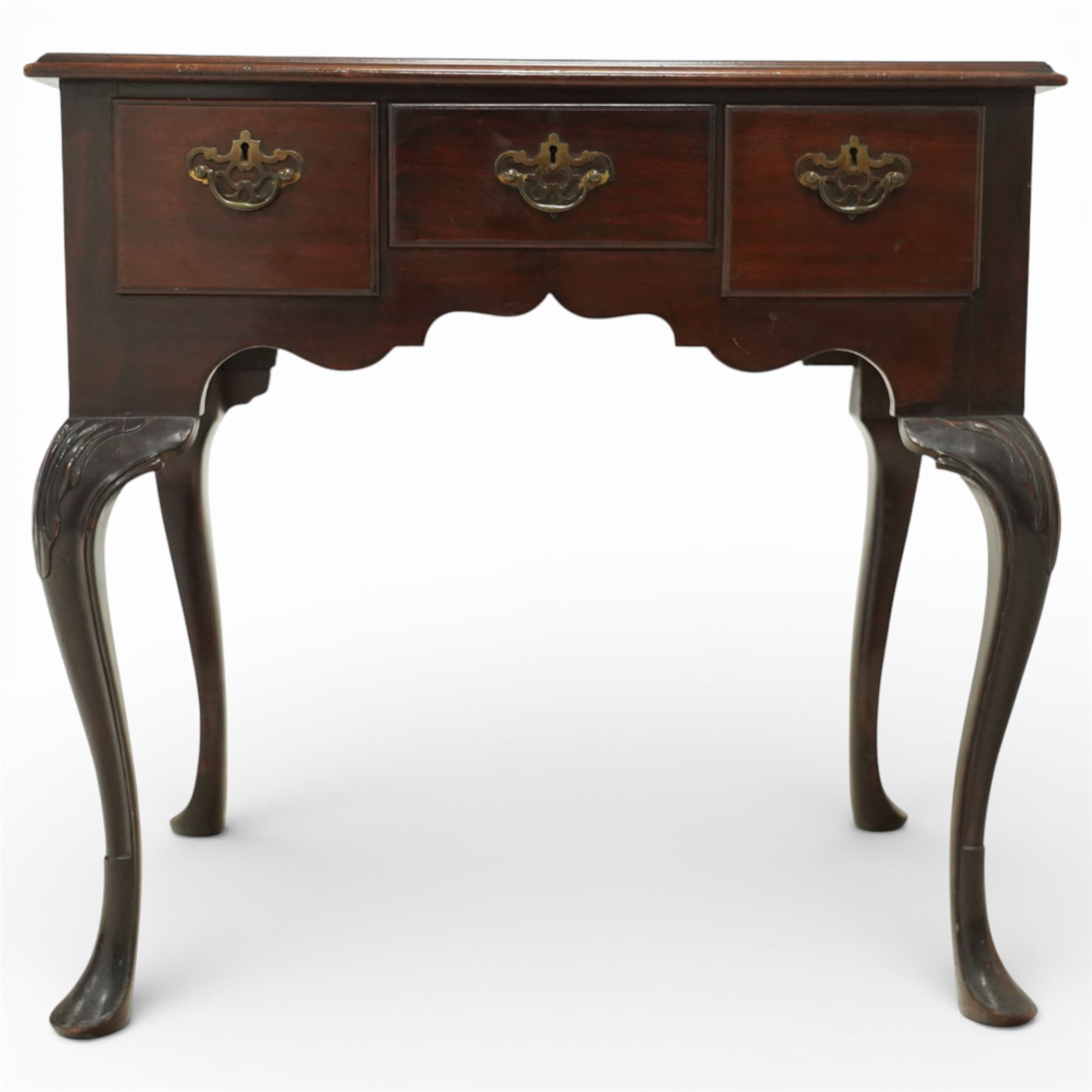 Early 20th century Irish mahogany lowboy, rectangular moulded top over three frieze drawers fitted with brass swan neck handles and escutcheons, shaped apron, raised on cabriole supports terminating in pad feet