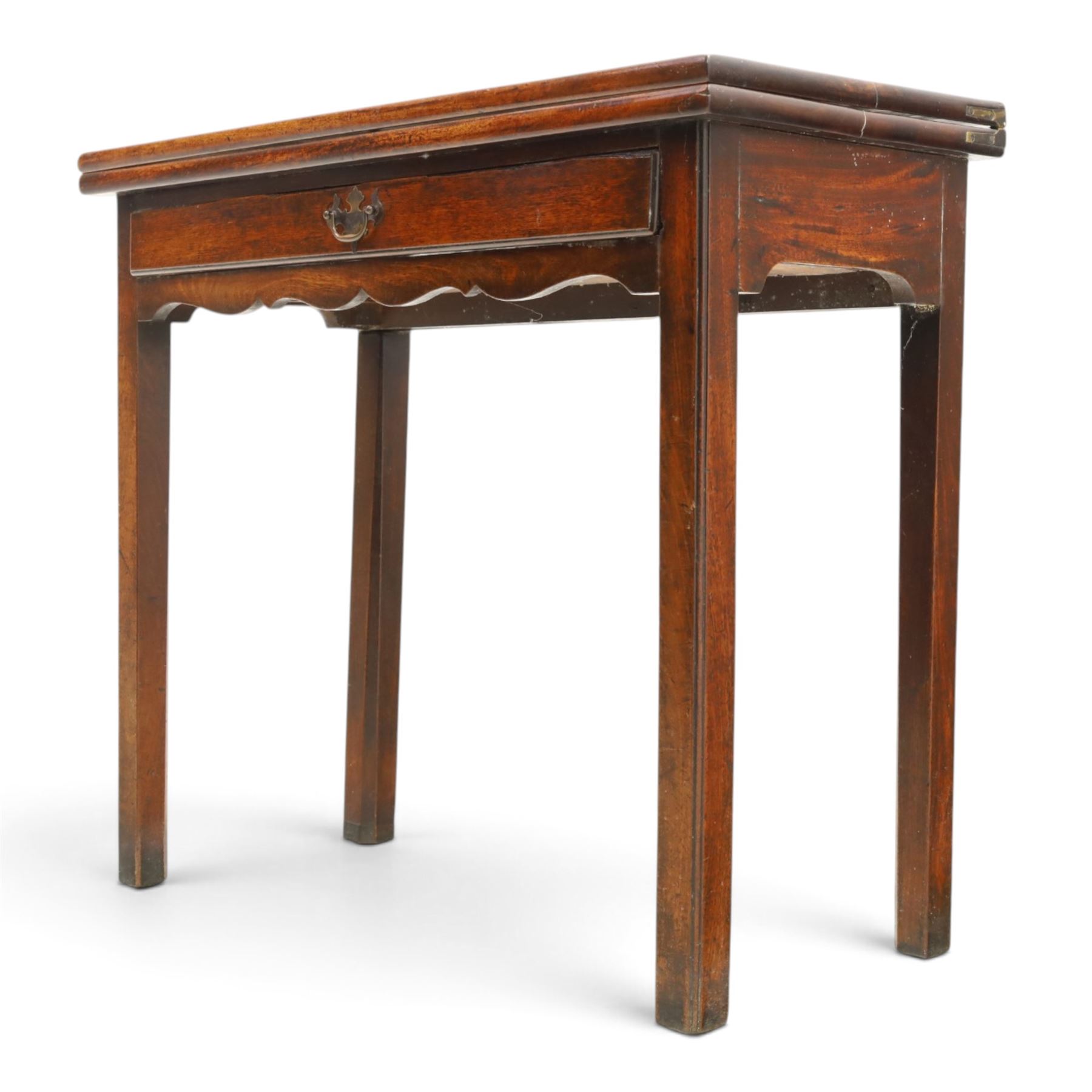 Georgian oak tea table, rectangular fold-over top above single frieze drawer with brass swing handle, shaped apron, gateleg raised on square tapering supports