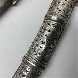 Moroccan jambiya dagger with 24.5cm plain curved blade stamped LONDON to the ricasso area, the hilt and scabbard overlaid with plain sheet brass to the back and ornate silver coloured metal to the front; waisted grip and arched pommel; two pyramid mounts to the scabbard L41cm overall; large billhook with curving blade and stacked leather washer grip; and a reproduction halberd blade (3)