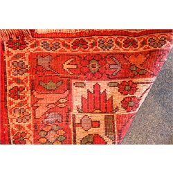  Persian style red ground rug, three central medallions, repeating border, 235cm x 180cm  