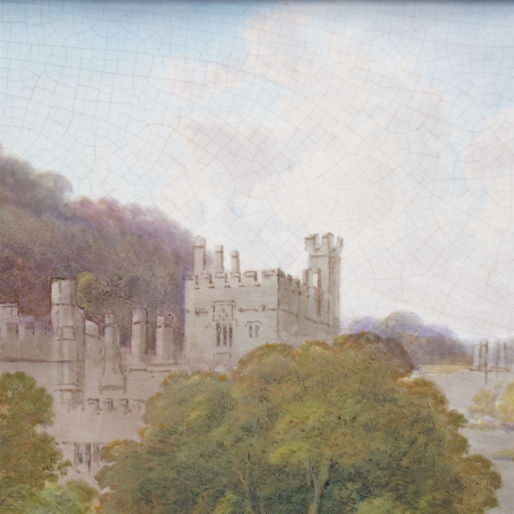 English porcelain plaque depicting Haddon Hall, with painted title and 'R' signature verso, overall 25.5cm x 35cm 
