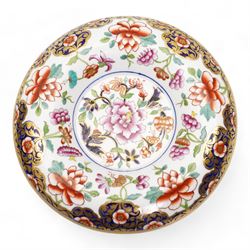 Early 19th century Spode spill vase, of cylindrical form with flared rim, hand painted with a Green Woodpecker perched on a branch, within beaded borders, titled beneath, H16cm, together with a Spode chocolate cup turnover rim stand, decorated in the imari pattern, no. 2630, painted marks beneath, D14cm (2)