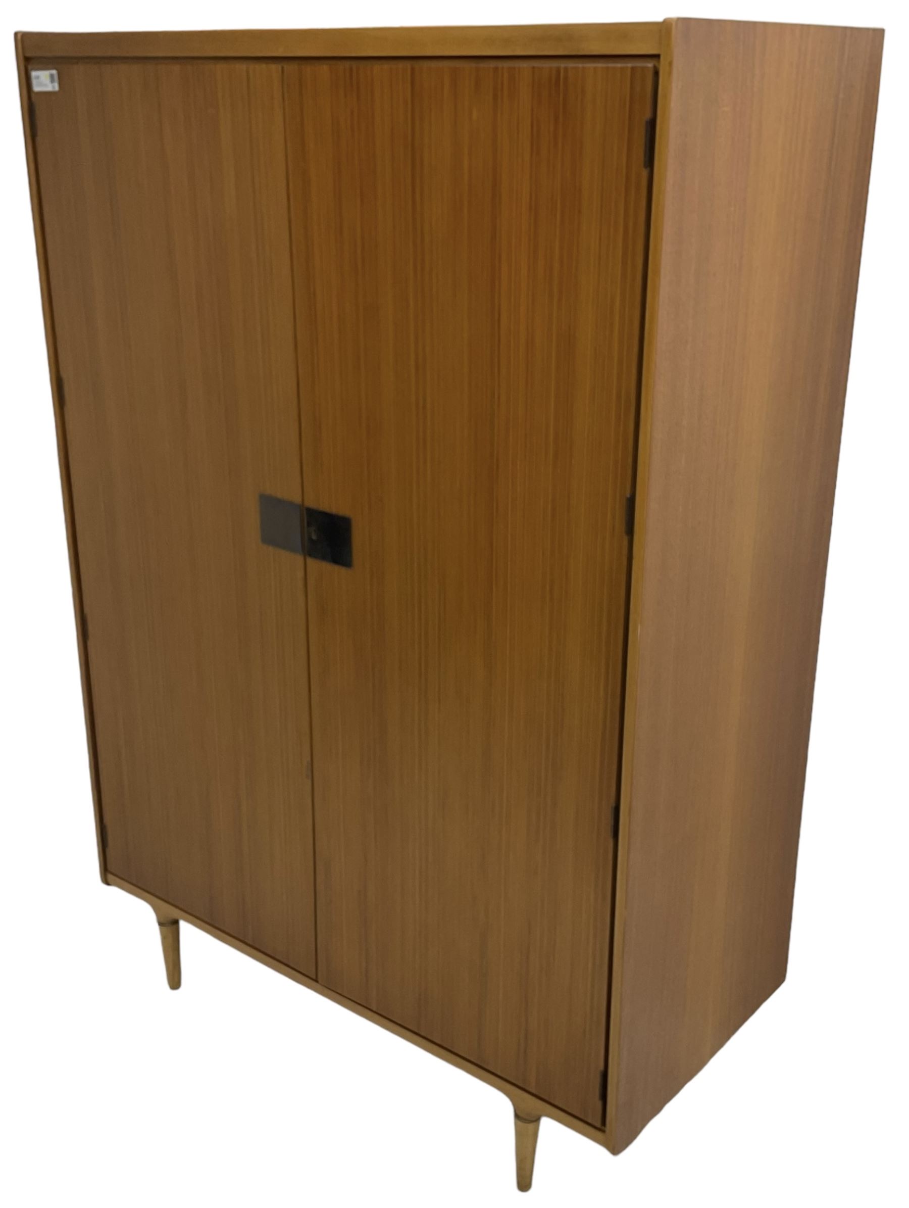 Wrighton - mid-20th century teak wardrobe, two doors enclosing hanging rail, shelves and hinged compartments, on turned tapering feet