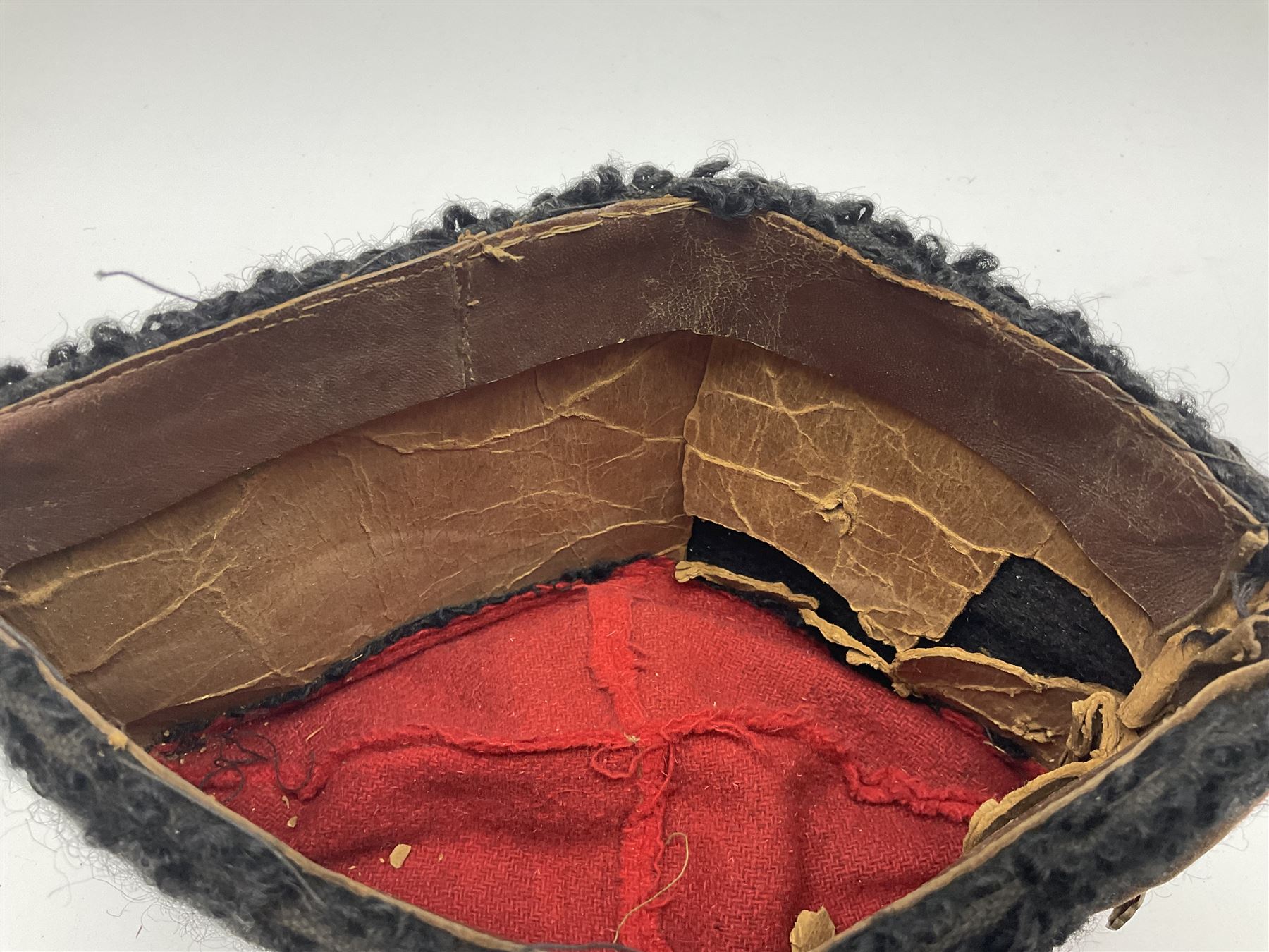 WW2 German small size Balkan style hat with 'SS' metal badges; red cloth top and flash to front with black persianelle type sides; lined in brown card with leather sweatband