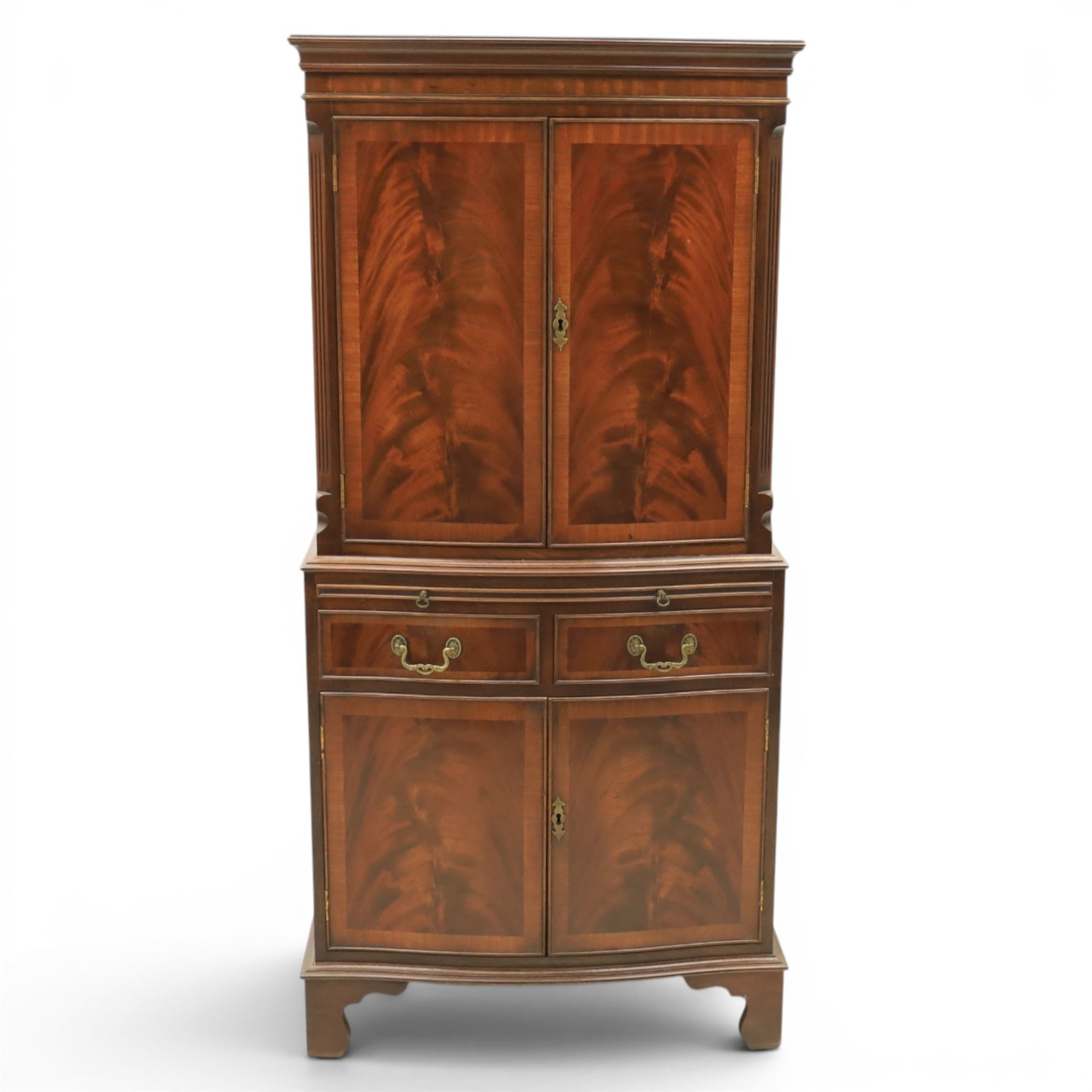 Georgian design mahogany cocktail drinks cabinet, bow fronted with mirrored and maple interior, slide out mirrored serving area, over two drawers and a cabinet below, raised on bracket feet
