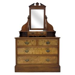 Victorian walnut bedroom suite - wardrobe, dressing chest and bedside cupboard, comprising a full-length wardrobe with broken pediment and central mirrored door, large lower drawer, a matching dressing table with bevelled swing mirror over two trinket drawers and two short drawers over two long drawers, and a single-door bedside cupboard, all with moulded edges, decorative panel work and shaped aprons