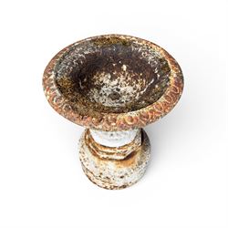 Victorian cast iron garden urn, egg and dart rim with shallow bowl, raised on stepped circular pedestal, finished in weathered white paint 