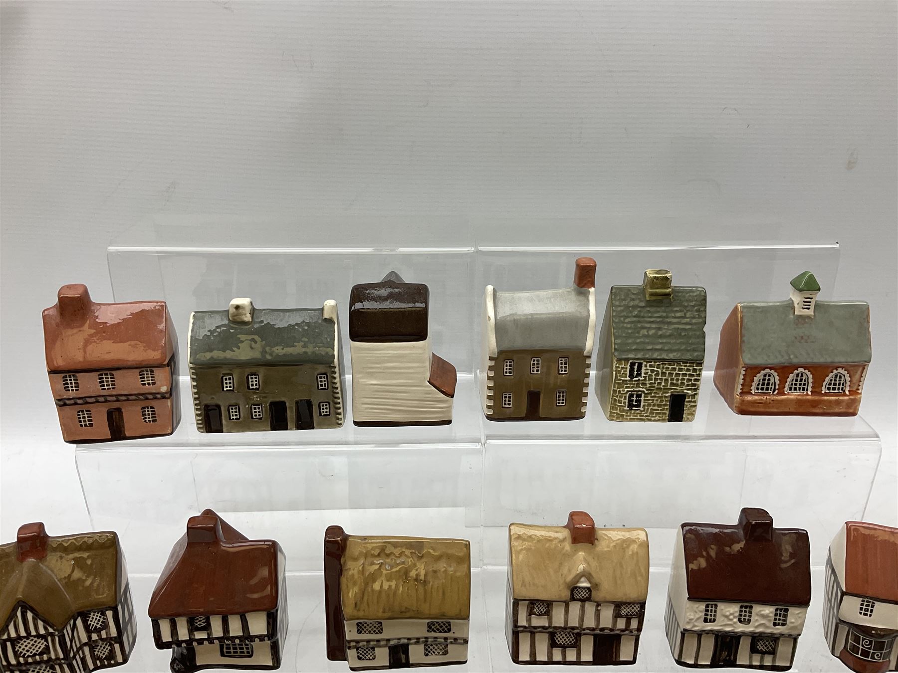 Twenty studio pottery figures of houses and cottages, comprising seventeen Mudlen End Studio Felsham Suffolk examples and two John Putman's Heritage Houses examples