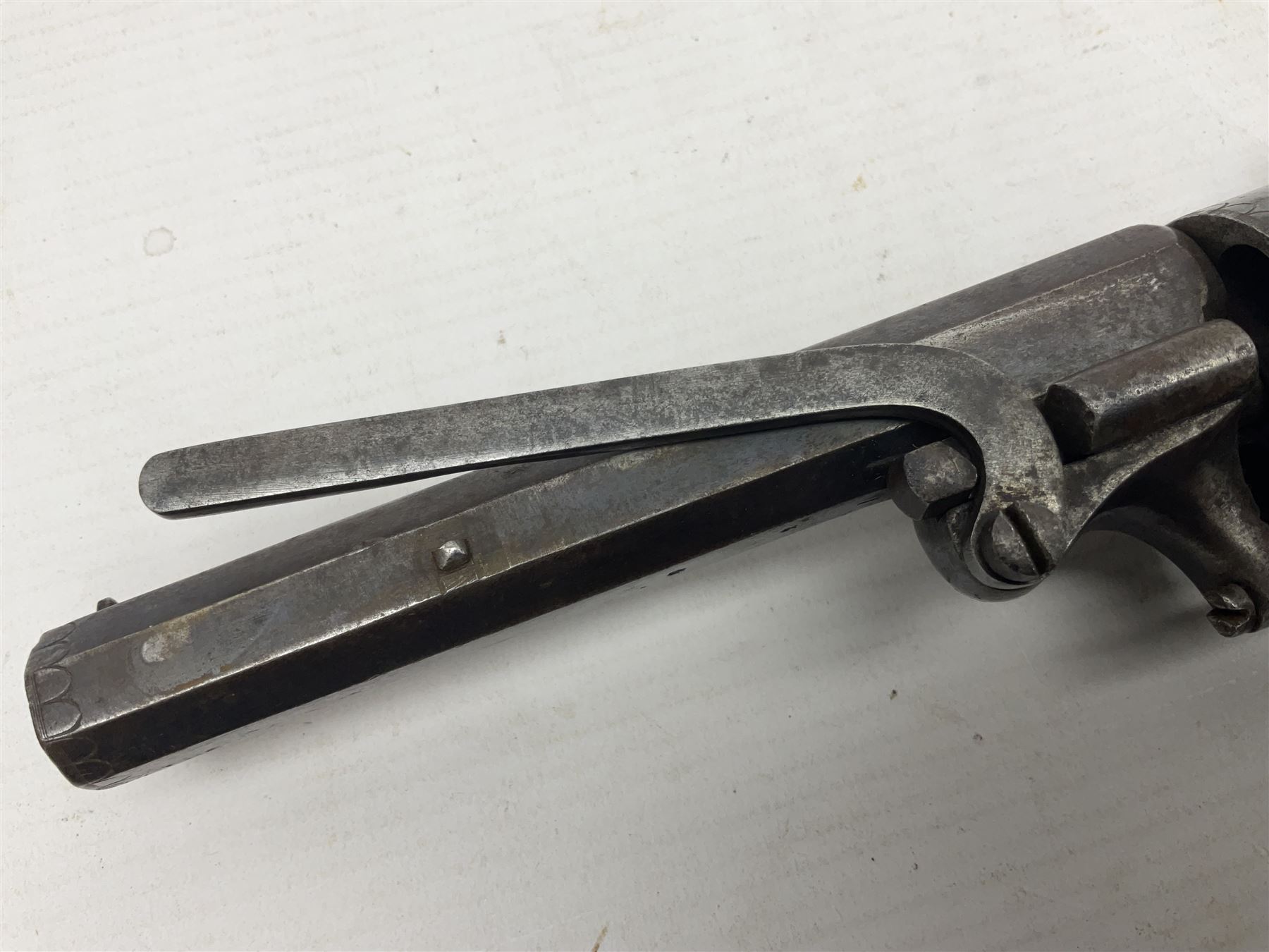 Mid-19th century Smith London .36 cal. transitional five-shot percussion revolver, the 12cm rifled octagonal barrel with side loading lever, side safety, some engraved decoration and chequered two-piece grip L28cm overall