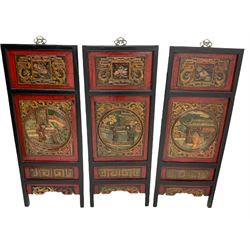 Set of three 19th century Chinese panels, the carved panels depicting figures in traditional landscape, scrolled dragon motifs and lattice effect decoration