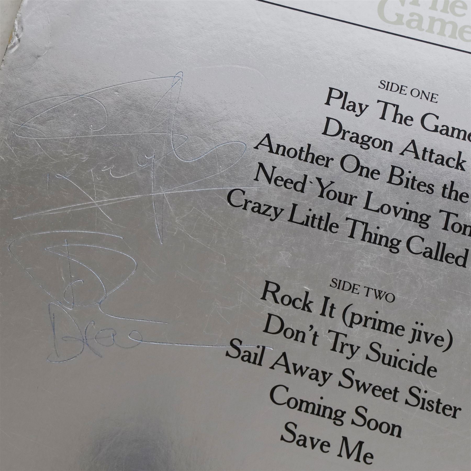 Queen 'The Game' signed vinyl record, signed to the reverse of the mirrored silver sleeve by Freddie Mercury, Roger Taylor and John Deacon, released by EMI records 1980

Provenance by vendor repute: Queen played at Elland Road in Leeds 29th May 1982; the vendor met the band the day before and had this record signed by the three members, but Brian May had not yet got off the train. The vendor called up the hotel and impersonated the band's then manager, Gerry Stickles, (by putting on an Australian accent!) to ask what time the band were arriving, then waited for them at the hotel.