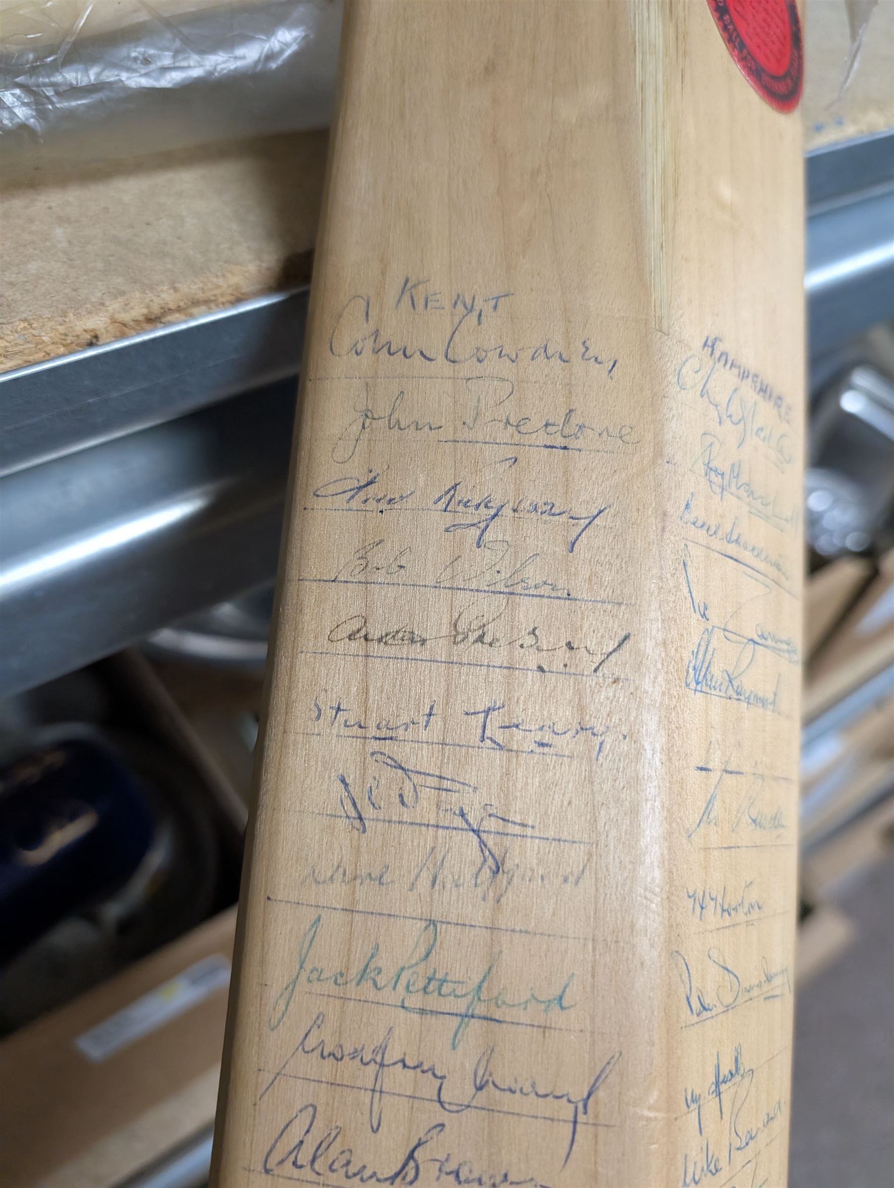 Two signed cricket bats, with signatures including Colin Cowdrey