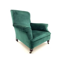 Late Victorian mahogany armchair, upholstered in green fabric, turned supports with castors