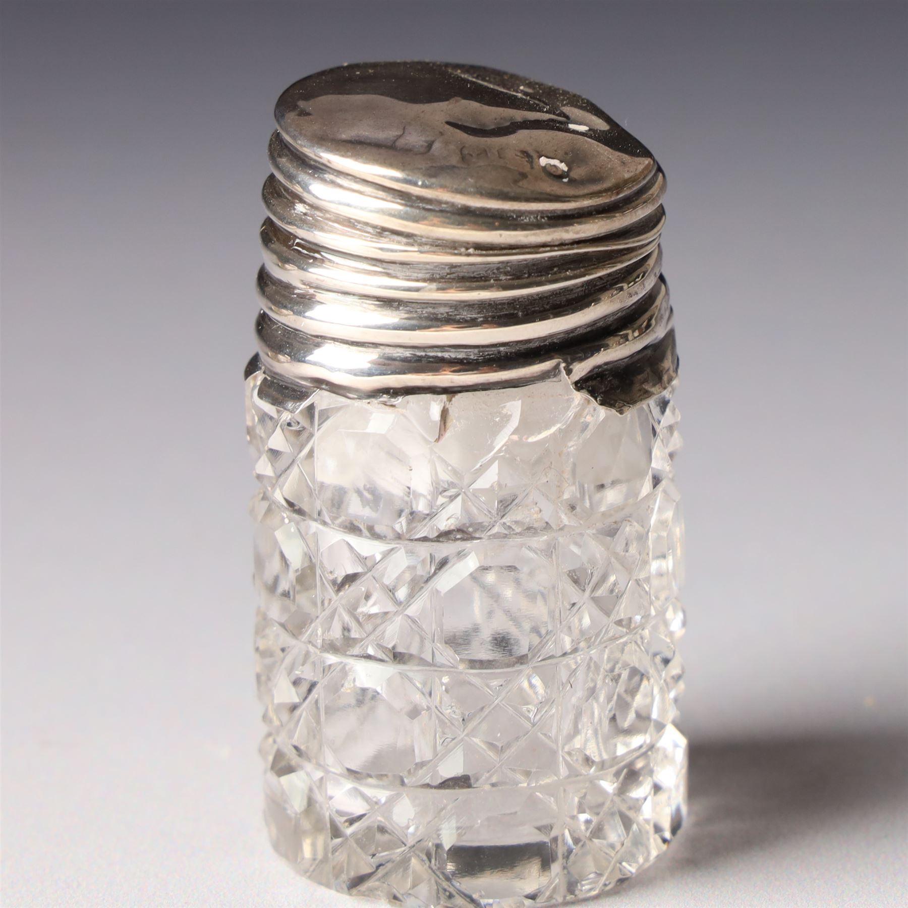 Silver upright photograph frame, aperture size 14cm x 9.5cm Birmingham 1919, pair of glass scent flasks with silver collars H16cm , two others, two dressing table jars with silver covers and a silver candlesticks
