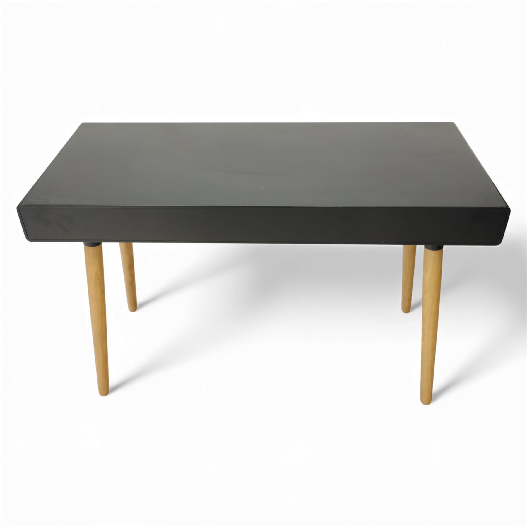 Modern black single drawer desk, black rectangular top above a single oak veneered drawer with black metal pull, flanked by two open shelves raised on tapering oak veneer legs (From floor to underside 64cm)