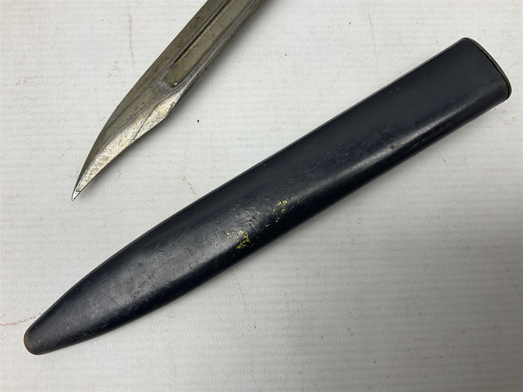 British No 7 MKI knife bayonet with 20cm single edged fullered clipped point blade;  blackened steel, large muzzle ring cross-guard; blackened swivelling pommel marked 'F5H'; red Tufnol composite grips; in blackened steel scabbard L33cm overall; British Pattern 1888 bayonet with scabbard; and German Ersatz bayonet with scabbard (3)