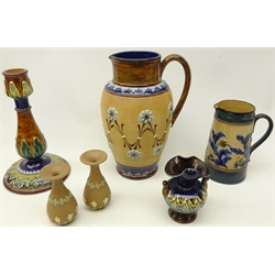  Doulton Lambeth stoneware pottery comprising a pitcher the body having coiled decoration with flower roundels and stylised leafage, artists monogram for Nellie Garbet, H22cm, tapered jug, small vase and pair of miniature Silicon vases and Royal Doulton stoneware candlestick (6)  