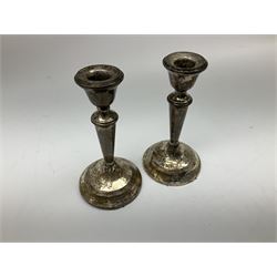 Pair of small silver filled candlesticks, hallmarked London 1921, maker's mark JE, H13cm, together with a silver plated figure group of two dogs, upon naturalistically modelled base stamped ARGENTOROX, upon rectangular plinths, H8.5cm L14cm