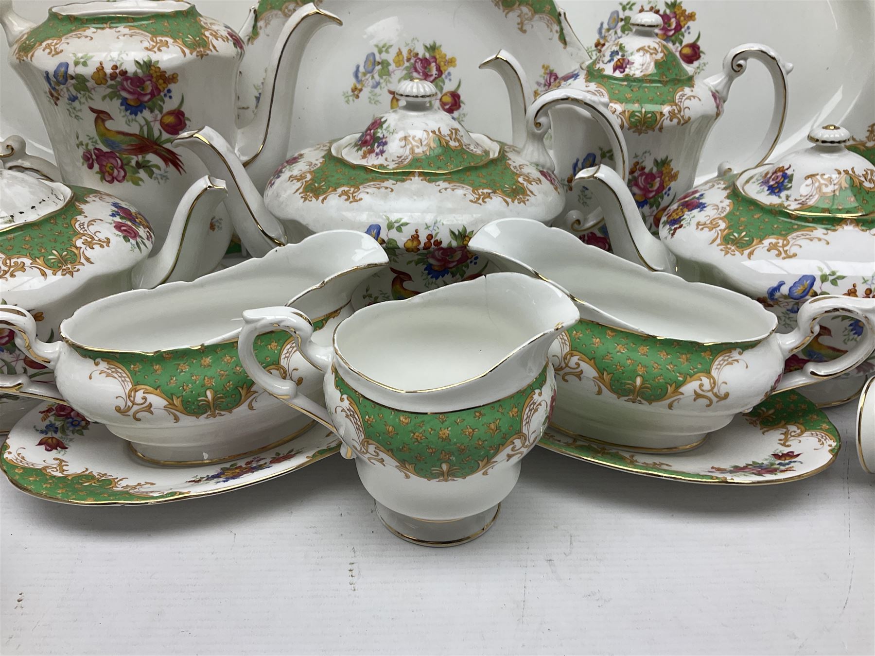 Paragon Rockingham pattern part tea and dinner service including three teapots, milk jug, cups and saucers of various sizes, ten soup bowls, ten side plates, ten dinner plates etc (96)