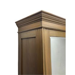 Late Victorian satin walnut compendium wardrobe, projecting moulded cornice and galleried top, the left hand side enclosed by bevelled mirror glazed door, the right hand side enclosed by panelled door carved with green man mask, trailing acanthus leaves and ribbons, two drawers below, the base fitted with single long drawer, on moulded skirt 