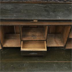 Early 20th century Chinese export carved hardwood writing bureau, the sloped fall front deeply carved with a narrative figural scene beneath pine and prunus trees, above a pair of rectangular carved panels, the shaped crest rail with entwined dragons, interior fitted with pigeonholes and a central drawer, on figural front supports with shaped stretcher