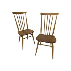 Ercol - pair of mid-20th century highback 'Windsor' chairs, curved top rail over six vertical spindles and shaped seat, on tapering cylindrical supports with stretchers