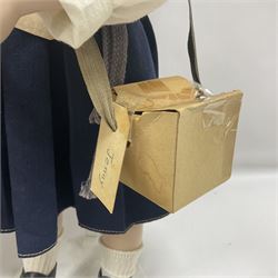 Mid-20th century woodwool filled teddy bear; and porcelain doll dressed as a WW2 evacuee