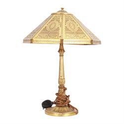 In the manner of Tiffany & Co, early 20th century gilt bronze Adam pattern table lamp, circa 1910, the circular spreading base decorated with flower heads and beaded bands, stiff leaves and husks, leading to a reeded column detailed with stiff leaves and swags, supporting a pierced octagonal shade, with original fittings, stamped beneath Tiffany Studios New York 539, overall H44.5cm


