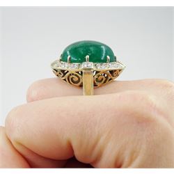 Gold emerald and diamond ring, the central oval cabochon emerald, with sixteen round and rectangular cut diamond halo surround by Judith Crowe, hallmarked 9ct, emerald 20.00 carat, total diamond weight 2.00 carat, with World Gemological Institute report