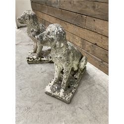 Pair of cast stone garden dogs and 2 female figures,