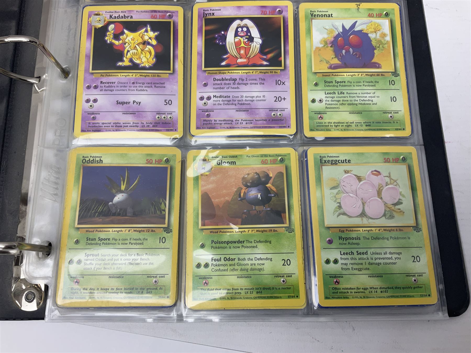 Collection of Pokemon trading cards, mostly 1999 Wizards Pokemon cards to include holo Charizard 4/102, first edition holo Machamp 8/102, further holographic cards; Dark Flareon 35/82 and Dark Vaporeon 45/82, cards from themed sets and 4th edition prints; 1998 Electronic Pokédex with cardboard boxes for themed decks Blackout, Overgrowth and Power Reserve Jungle, along with a large quantity of energy and trainer cards 