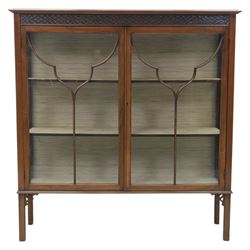 Edwardian mahogany display cabinet, blind-fretwork frieze over astragal glazed doors, square legs with fretwork detail