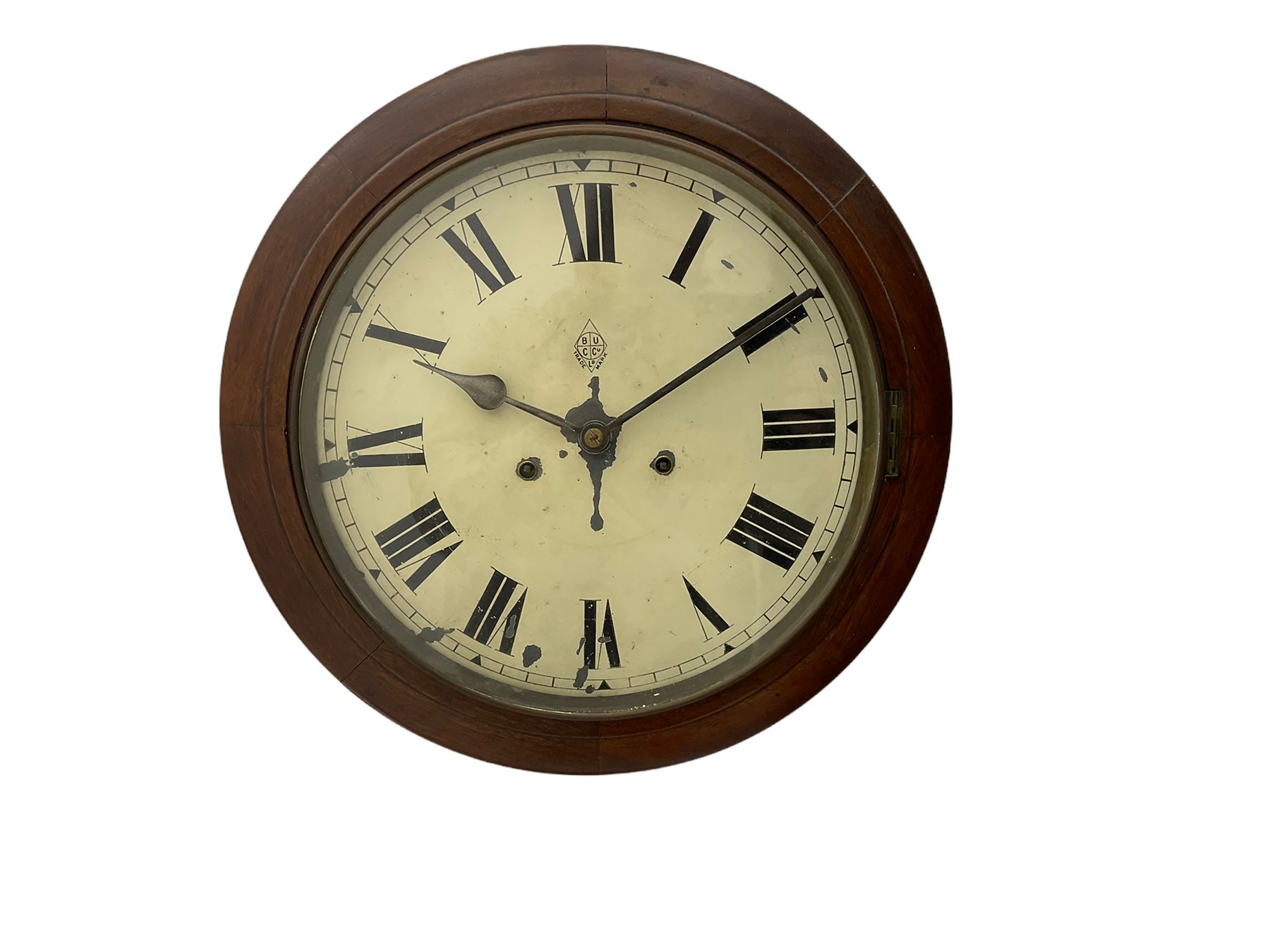 An early 20th century English wall clock with a circular 16” mahogany wooden bezel, 12” painted steel dial with Roman numerals and minute track, steel spade hands within a flat glass and spun brass bezel, eight-day rack-striking spring driven movement striking the hours on a coiled gong, with case side door and pendulum regulation door to base, dial inscribed with the trademark BUC Ltd . 
( British United Clock Company 1885-1909)
With pendulum and key.



